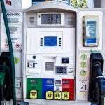 Detalhe de uma bomba de combustível com opções de gasolina e óleo diesel em um posto.